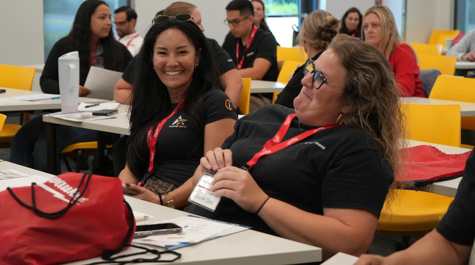 Conference attendees smiling and listening during a construction industry workforce session