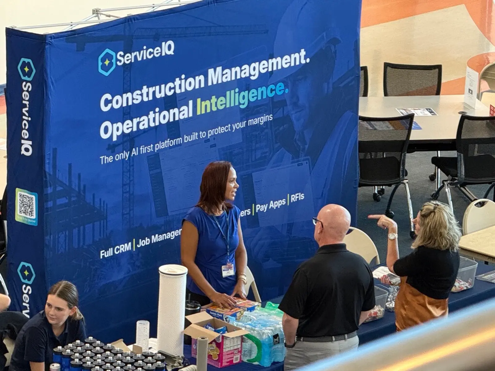 ServiceIQ team members speaking with attendees at their expo booth at Manufacturing & Technology Day